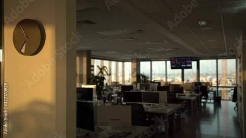 Empty modern office in the early morning, nobody inside, summer, sunrise, sunlight is moving at the wall with clocks. Time-lapse, 4K, Cyprus, Limassol