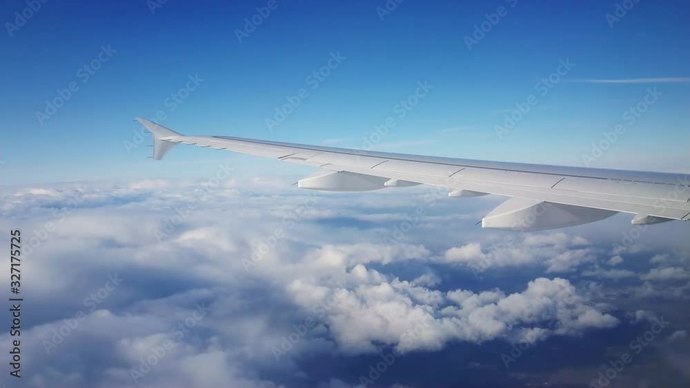 beautiful Sky and wing of an airplane from the porthole of an airplane beautiful Sky and wing of an airplane from the porthole of an airplane