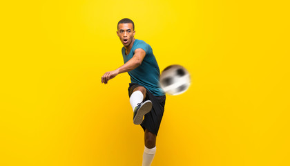 Afro American football player man over isolated yellow background