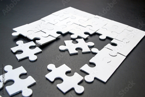 White puzzles on a black background close-up
