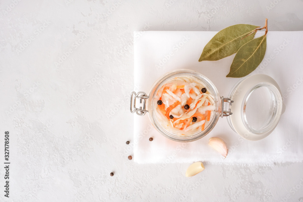 Fermented food. Sauerkraut with black pepper in a glass bowl on a light gray concrete background. Top view, copy space. Fermented food. Sauerkraut with black pepper in a glass bowl on a light gray concrete background. Top view, copy space.