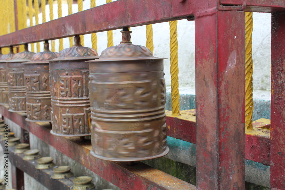 buddhist prayer wheels in nepali temple
