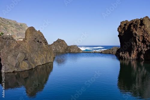 Natural pool with black volcanic rock in the Atlantic Ocean (Madeira, Portugal, Europe)