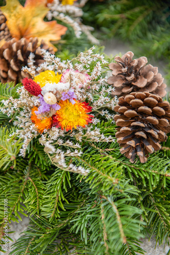flower arrangement with cones and fir branch