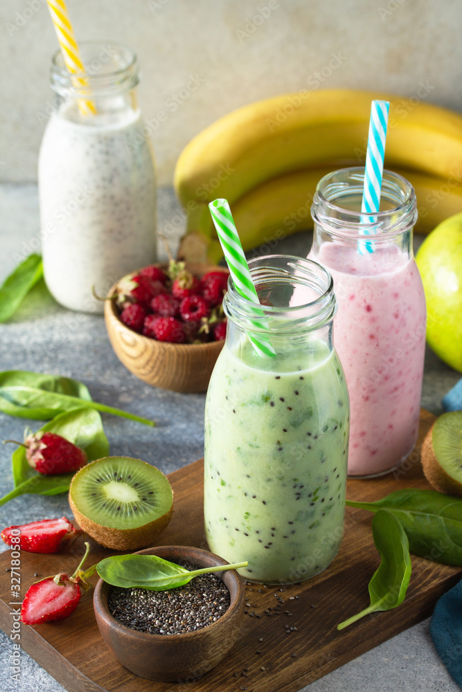 The concept of a healthy diet and diet. Green Detox mixed smoothies vegetable and fruit with organic ingredients on a stone concrete worktop. The concept of a healthy diet and diet. Green Detox mixed smoothies vegetable and fruit with organic ingredients on a stone concrete worktop.