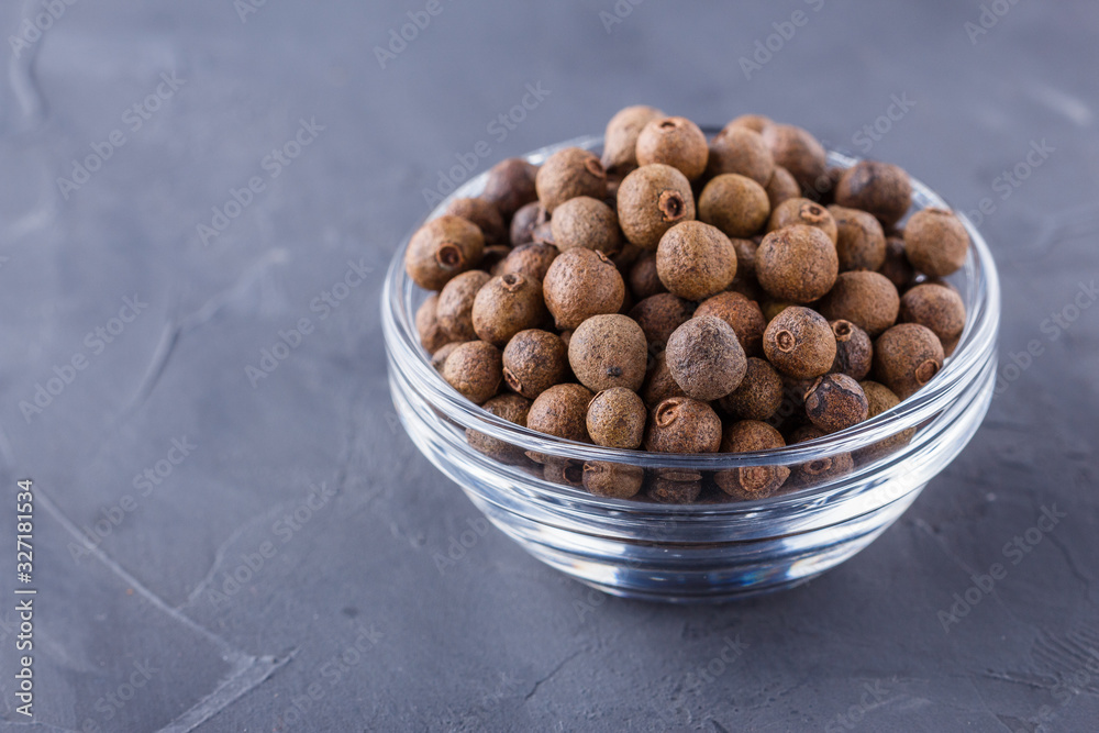 fresh spicy peppers allspice on a dark stone background fresh spicy peppers allspice on a dark stone background