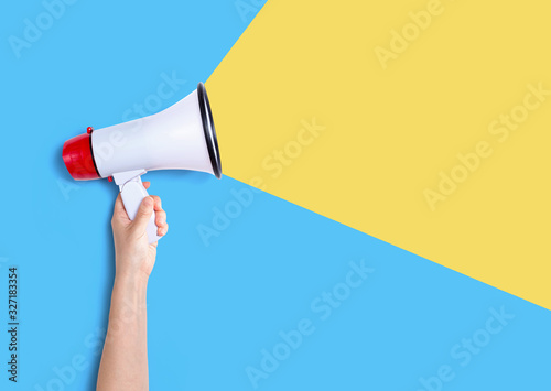 Person holding a megaphone with hard shadow