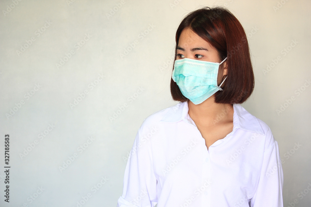 Viruses, Portrait of young woman wearing face mask for protect smog or PM 2.5 and viruses on white background, illness, Health concept Viruses, Portrait of young woman wearing face mask for protect smog or PM 2.5 and viruses on white background, illness, Health concept