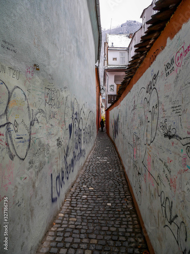 The colorful  Rope Street  ( in Romanian Strada Sforii) on medieval streets in Transylvania, Brasov city, one of the narrowest streets in Europe. photo