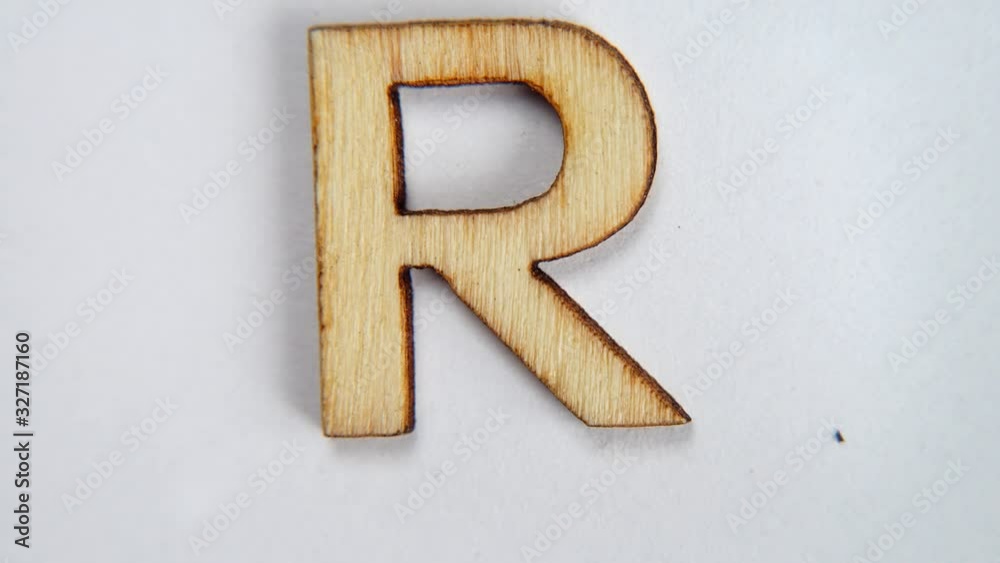 Wooden letter R of the English alphabet. Letter moves on a white ...