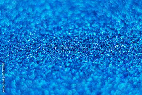 Blue shiny background. Bokeh. Glitter. The side with sequins. Classic blue. Magic