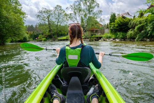 Fototapeta Naklejka Na Ścianę i Meble -  A woman kayaking down the river Wda in Kaszuby, Poland