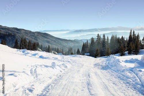 Empty road covered with snow on winter day © New Africa