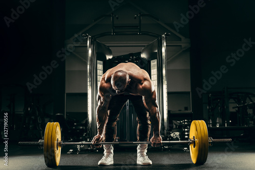 Bodybuilder athletic man back muscles deadlift
