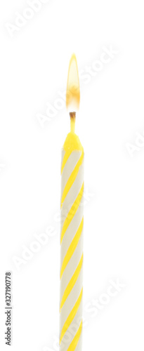 Yellow birthday cake candle isolated on white