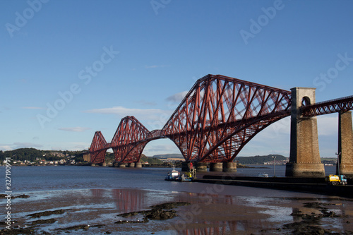 red steel bridge over river 