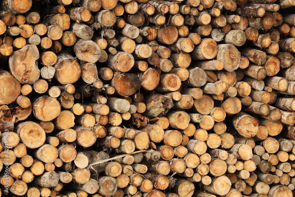 Stacked firewood as background. Heating house in winter Stacked firewood as background. Heating house in winter