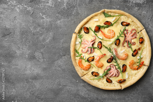 Delicious seafood pizza on grey table, top view. Space for text