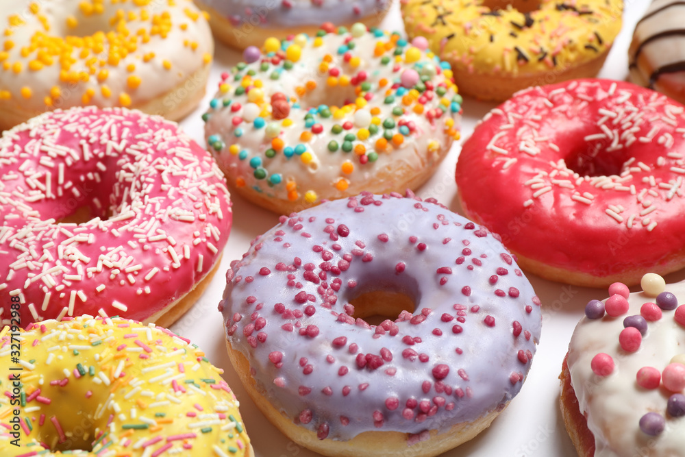 Delicious glazed donuts on white background, closeup Delicious glazed donuts on white background, closeup