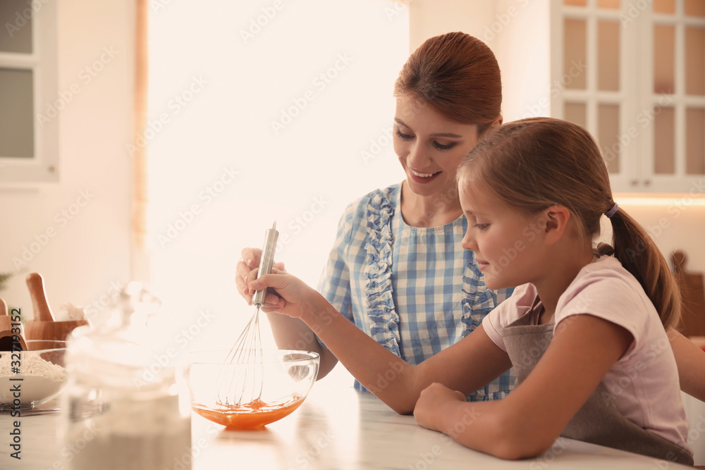 Mother and daughter making dough together in kitchen Mother and daughter making dough together in kitchen