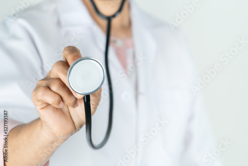 senior doctor or physician hold stethoscope in the hospital. Concept Of Medical Technology and Healthcare Business