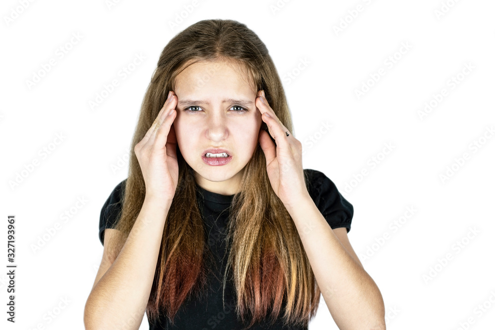 A young teenage girl holding her head and suffering from a headache. The girl became angry because she was very ill. Copy space A young teenage girl holding her head and suffering from a headache. The girl became angry because she was very ill. Copy space