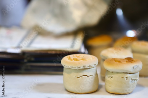 The liturgical liturgical bread of Prosphorus, Prosphora used during Orthodox worship. Preparation for Holy Communion. hands of the priest, icons placed on the altar of the Orthodox Church. The concep photo