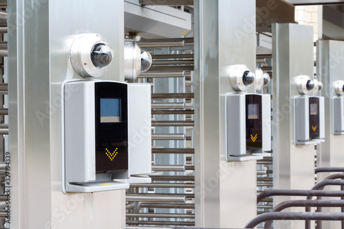 Modern turnstile at the stadium. Card access system, video surveillance, scanner, barrier. Close up.