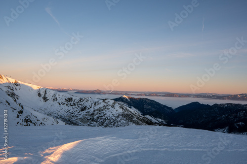 Sunrise in winter mountains with clear sky with view of High Tatras in background, Slovakia Low Tatras, dumbier