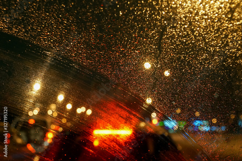 raindrops and a trace of the windshield wiper on the car