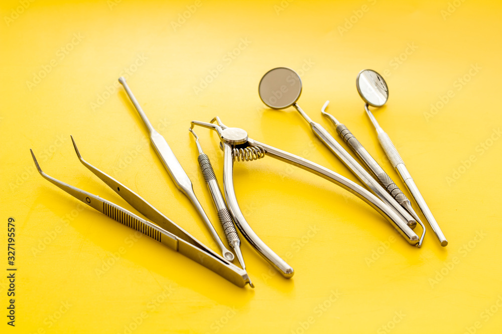 Dental instruments - set with mirrors - on yellow background close up