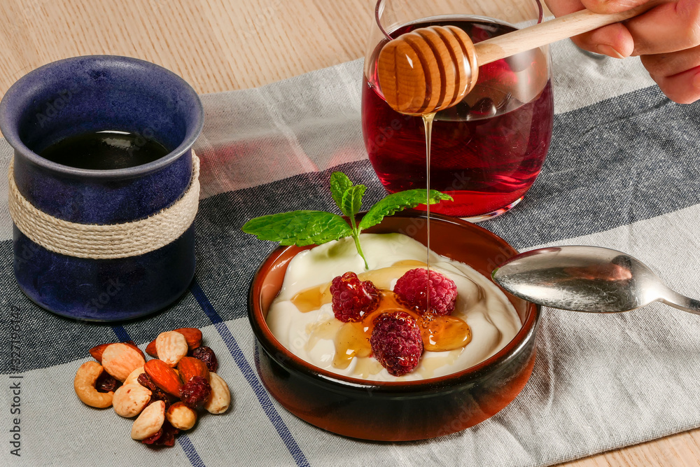 Fototapeta premium A plate of Turkish yogurt with berries, mint, avocado, and a glass of juice.