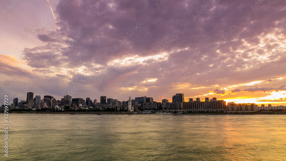 Sunset over the skyline of Montreal and the saint-laurent river from Jean Drapeau park