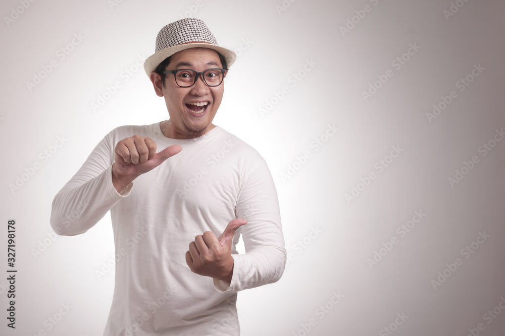 Young Man Showing and Pointing Something on His Side Young Man Showing and Pointing Something on His Side