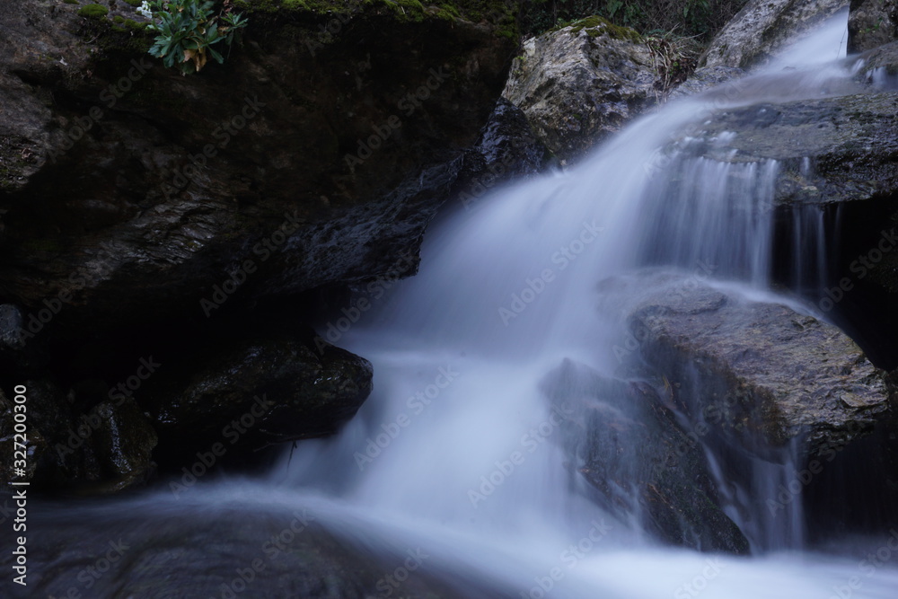 Fototapeta premium Water flows into a mountain river