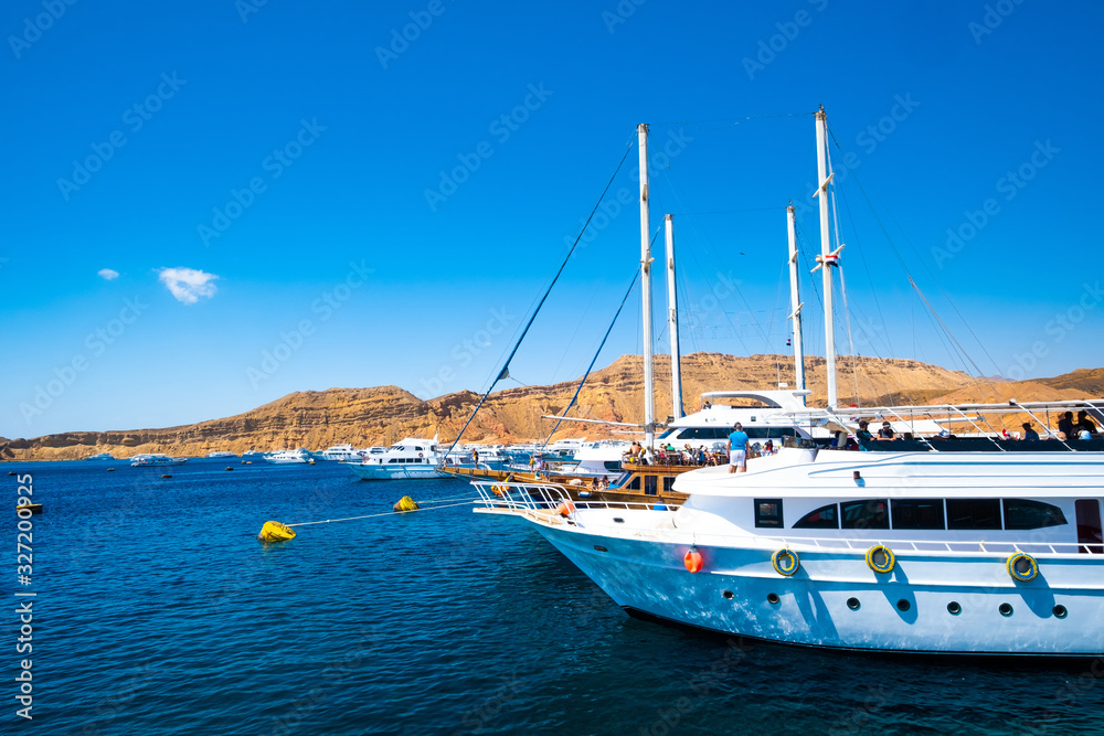 Natural view on gorgeous seaside with deep blue sea and luxurious yachts