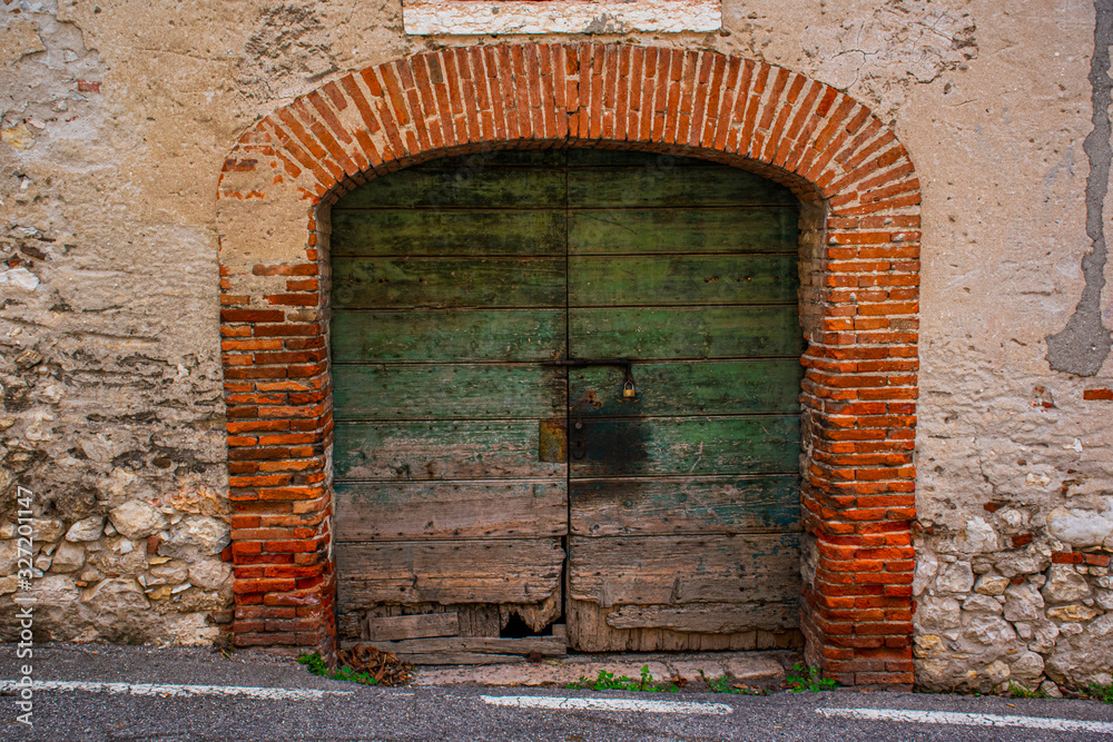 green wooden door and bricks