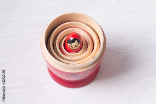 folk toy called a nesting doll embedded in the uncovered upper layers of the toy