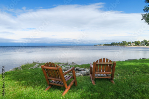 Peaceful view of two wooden chairs facing the lac St Jean, in Quebec © jonas
