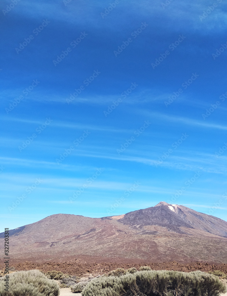 Panoramic view of Teide volcano in Tenerife against the blue sky, Canary island, Spain Panoramic view of Teide volcano in Tenerife against the blue sky, Canary island, Spain