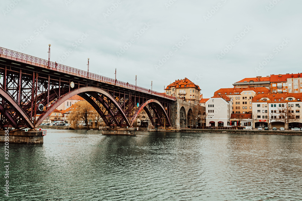 Naklejka premium Old Bridge or Main Bridge over the Drava River in the city of Maribor, Slovenia. Europe.