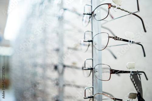Eyeglasses shop. Stand with glasses in the store of optics. Eyesight correction.
