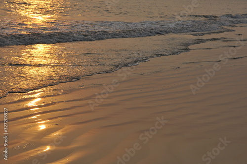 waves on beach at sunset
