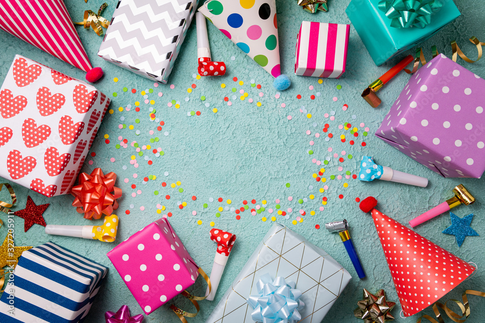 Fototapeta premium Happy birthday background. Party accessories confetti, gift boxes, party hats, wistle. Happy birthday celebrate concept. Top view, flat lay, copy space
