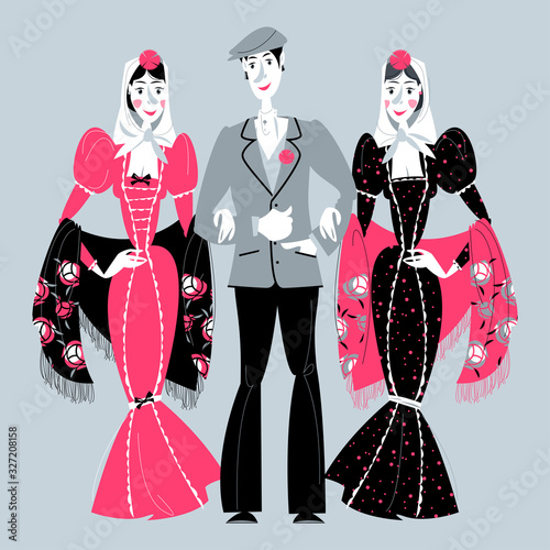 Man and two women in traditional clothes during the festival of “San Isidro” (Fiestas de San Isidro), patron of Madrid. photo