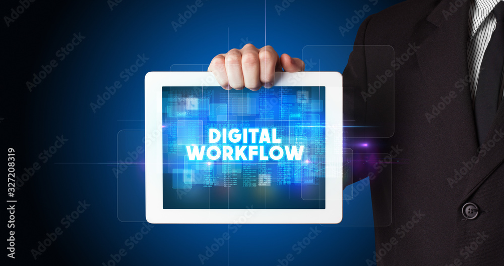 Young business person working on tablet and shows the inscription: DIGITAL WORKFLOW Young business person working on tablet and shows the inscription: DIGITAL WORKFLOW