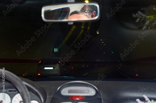Driving a car through a tunnel with lights of other vehicles