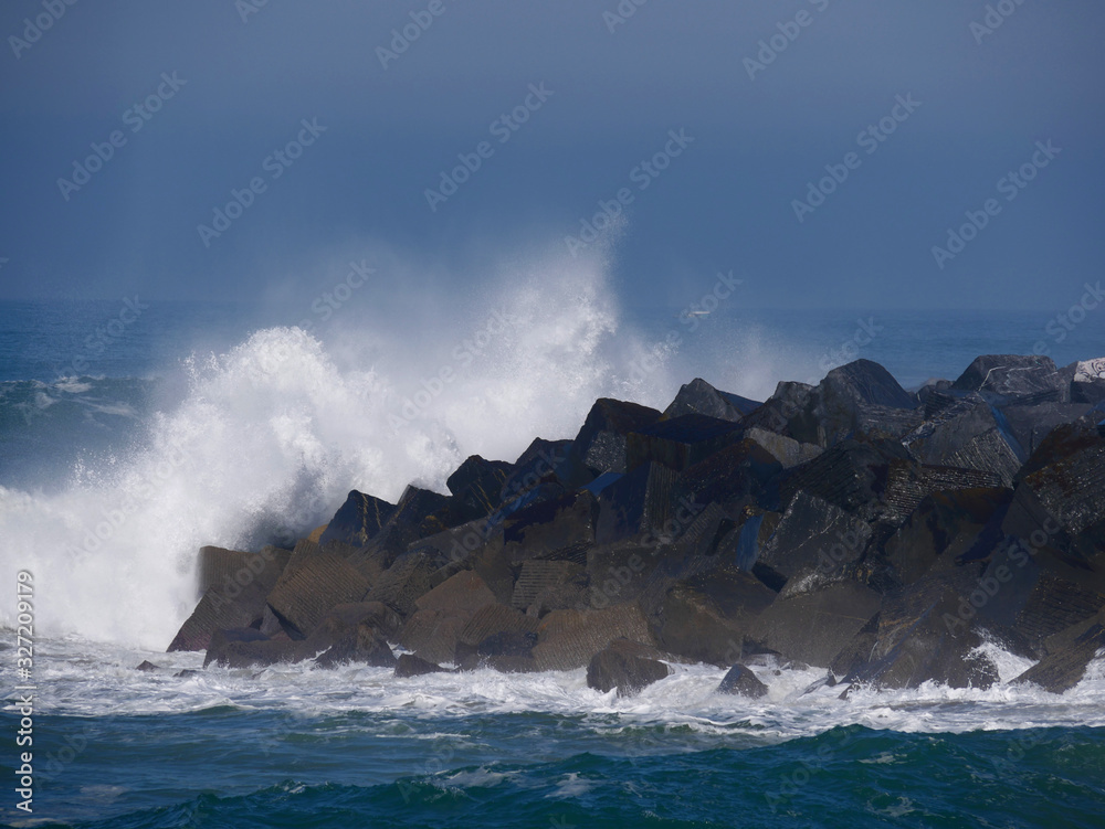 Fototapeta Waves crashing on a pier in San Sebastian