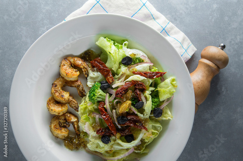 Grilled shrimps Healthy salad plate with blue line table cloth. Top view 