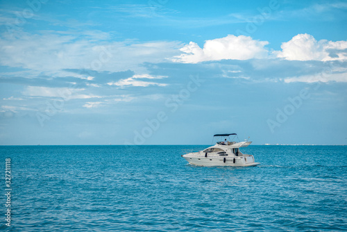 White yacht sails on the Caribbean sea, the sky is cloudy. © Kai Grim